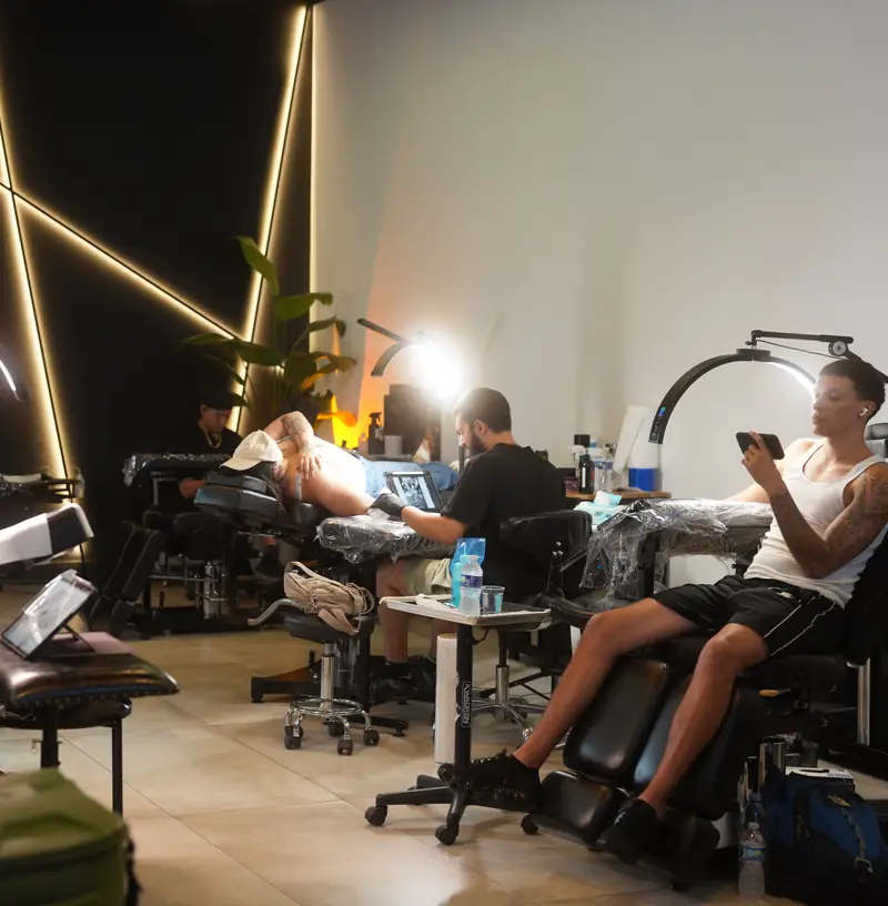 Artists tattooing clients across the Orlando Kings floor